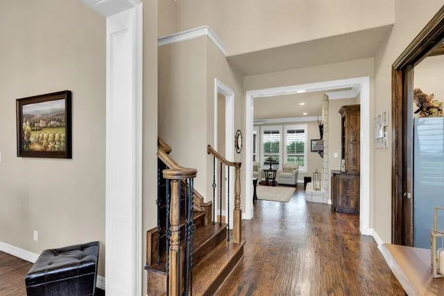a view of a hallway view with wooden floor and staircase