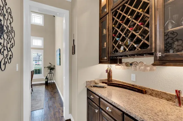 a kitchen with a granite countertop sink a stove and a wooden floor