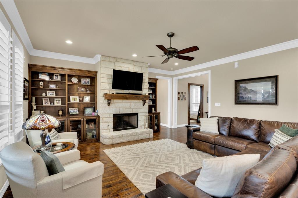 5631 Limestone Lane Midlothian, TX 76065 - Photo 10 of 40 a living room with furniture a fireplace and a flat screen tv