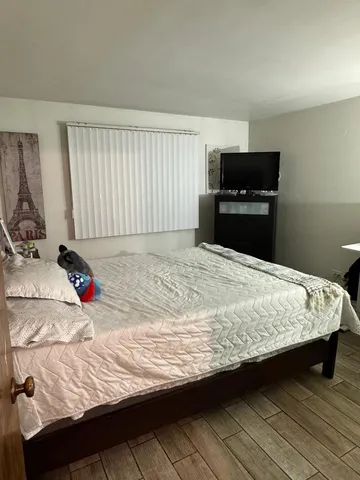 a bedroom with bed and window