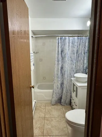 a bathroom with a toilet a sink and shower