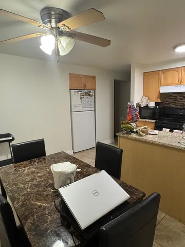 a view of a dining room with furniture and a window