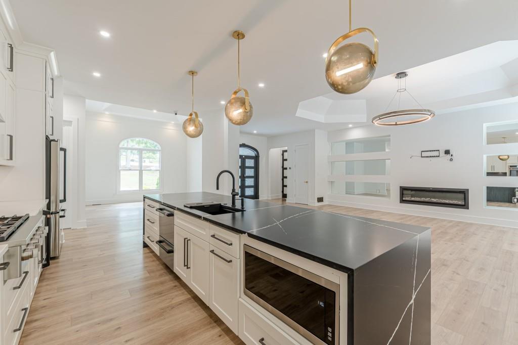 6394 Wood Valley Road Douglasville, GA 30134 - Photo 14 of 84 a large kitchen with stainless steel appliances a large counter top and a wooden floors