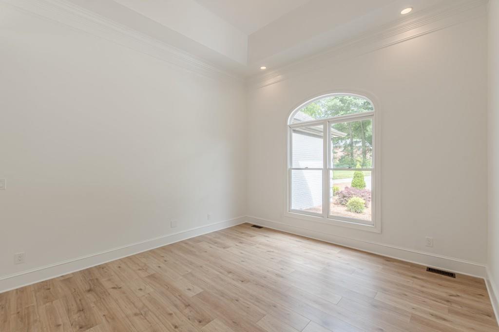 6394 Wood Valley Road Douglasville, GA 30134 - Photo 21 of 84 an empty room with wooden floor and windows