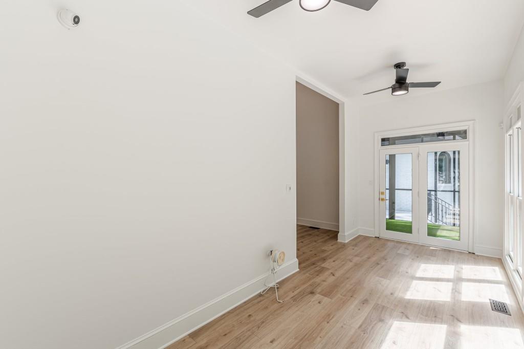 6394 Wood Valley Road Douglasville, GA 30134 - Photo 29 of 84 a view of a hallway with wooden floor and a ceiling fan