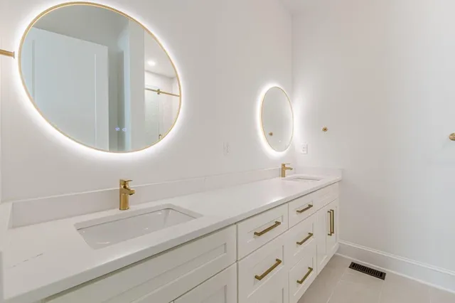 a bathroom with a tub a sink and a mirror
