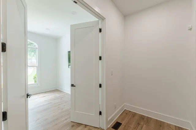a view of a house with a yard and palm trees