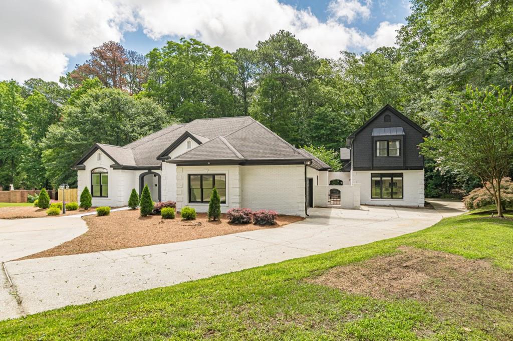 6394 Wood Valley Road Douglasville, GA 30134 - Photo 4 of 84 a front view of a house with a yard and garage