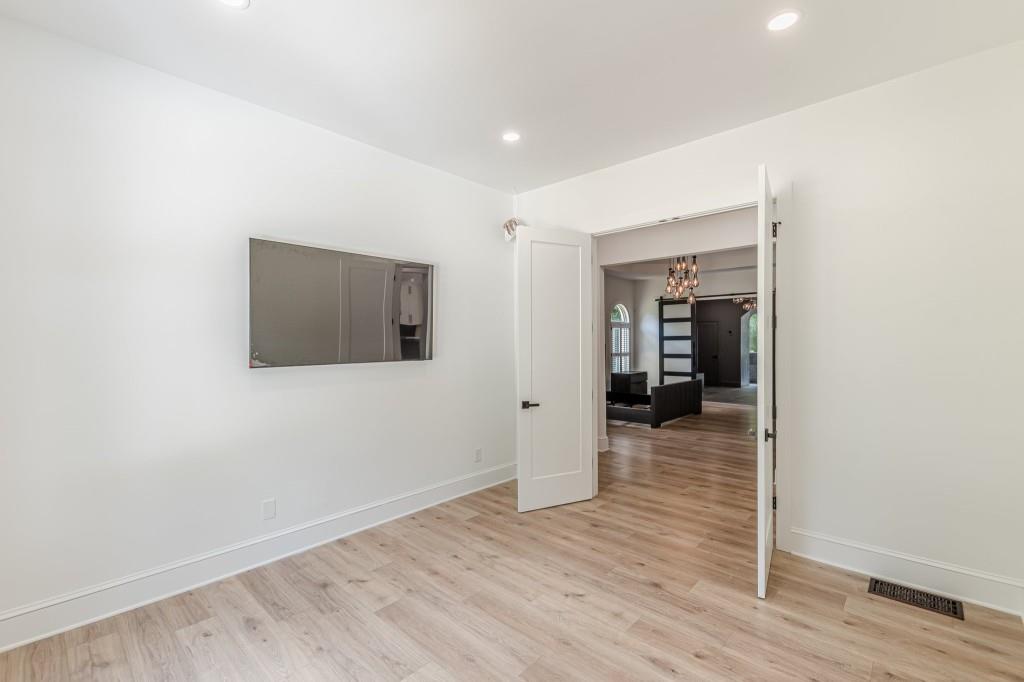 6394 Wood Valley Road Douglasville, GA 30134 - Photo 44 of 84 a view of a hallway with wooden floor and a bathroom