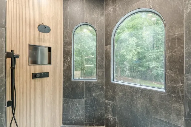 a bedroom with a large bed and a chandelier