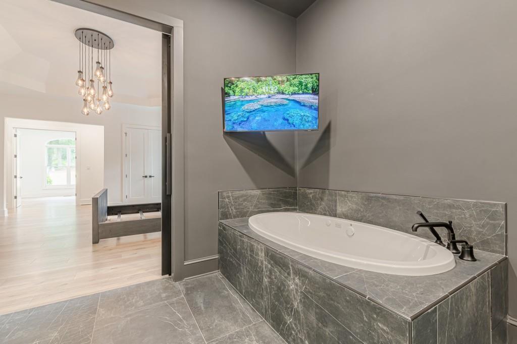 6394 Wood Valley Road Douglasville, GA 30134 - Photo 50 of 84 a bathroom with a tub a sink and a mirror