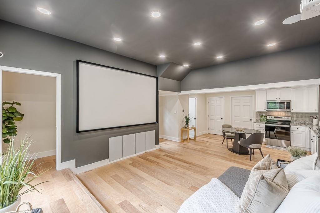 6394 Wood Valley Road Douglasville, GA 30134 - Photo 64 of 84 a bedroom with a bed a flat screen tv and couches