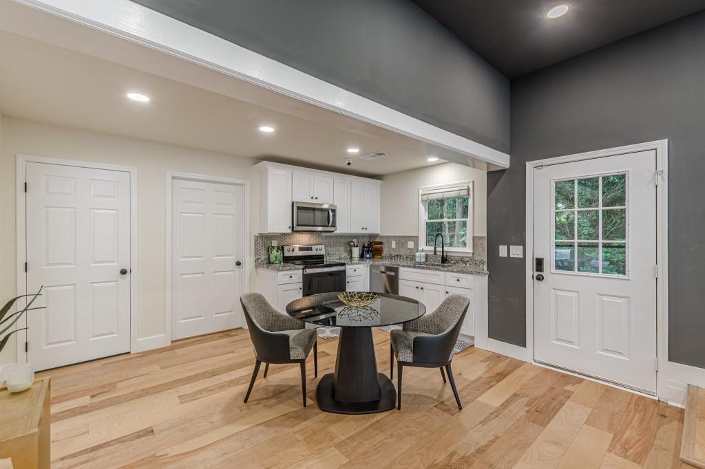 6394 Wood Valley Road Douglasville, GA 30134 - Photo 66 of 84 a view of a dining room with furniture and wooden floor