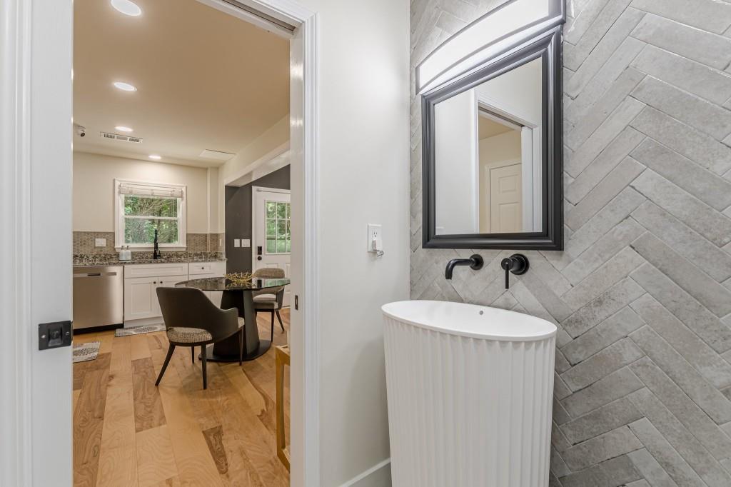 6394 Wood Valley Road Douglasville, GA 30134 - Photo 70 of 84 a en suite bathroom with a sink and a mirror