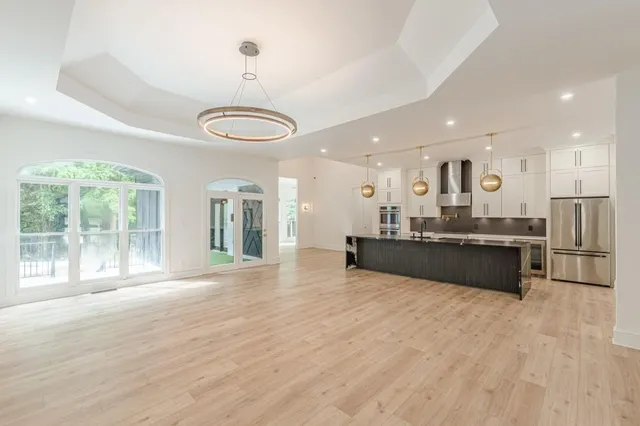 a large kitchen with granite countertop a stove oven and cabinets