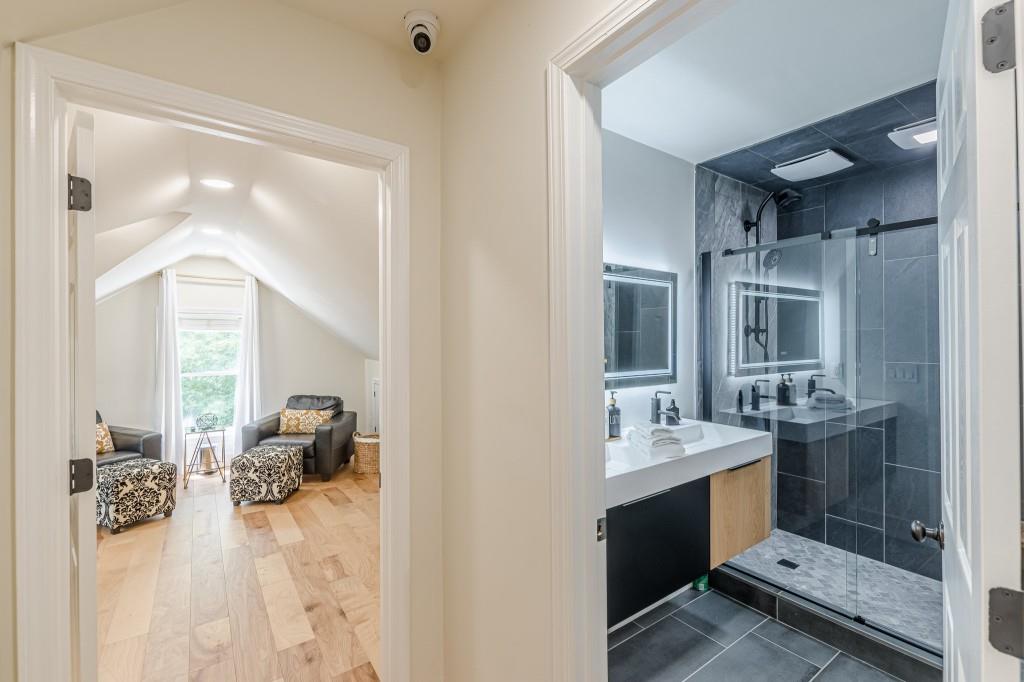 6394 Wood Valley Road Douglasville, GA 30134 - Photo 77 of 84 a en suite bathroom with a sink double vanity and a mirror