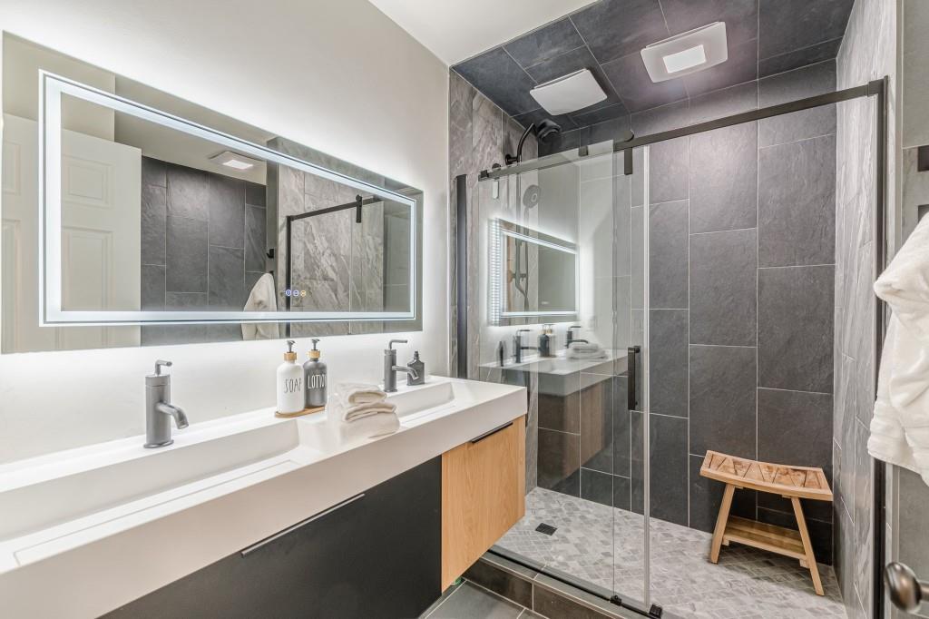 6394 Wood Valley Road Douglasville, GA 30134 - Photo 78 of 84 a bathroom with a sink a toilet a mirror and shower