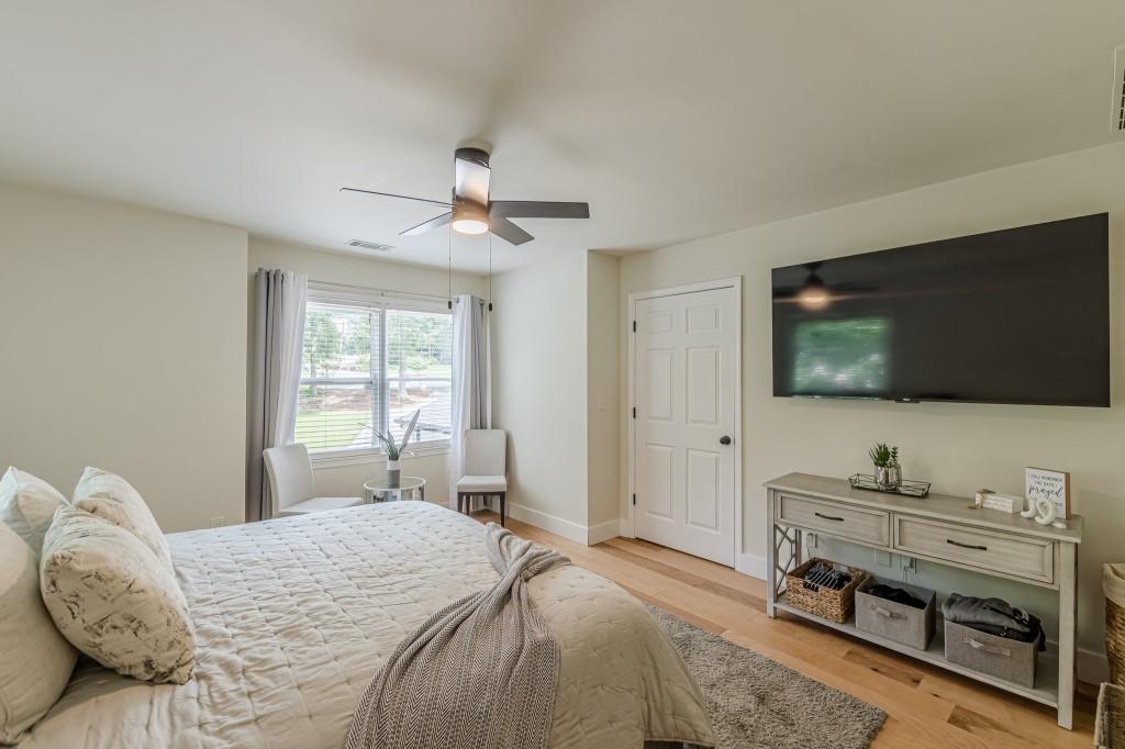 6394 Wood Valley Road Douglasville, GA 30134 - Photo 82 of 84 a bedroom with a bed and a flat screen tv