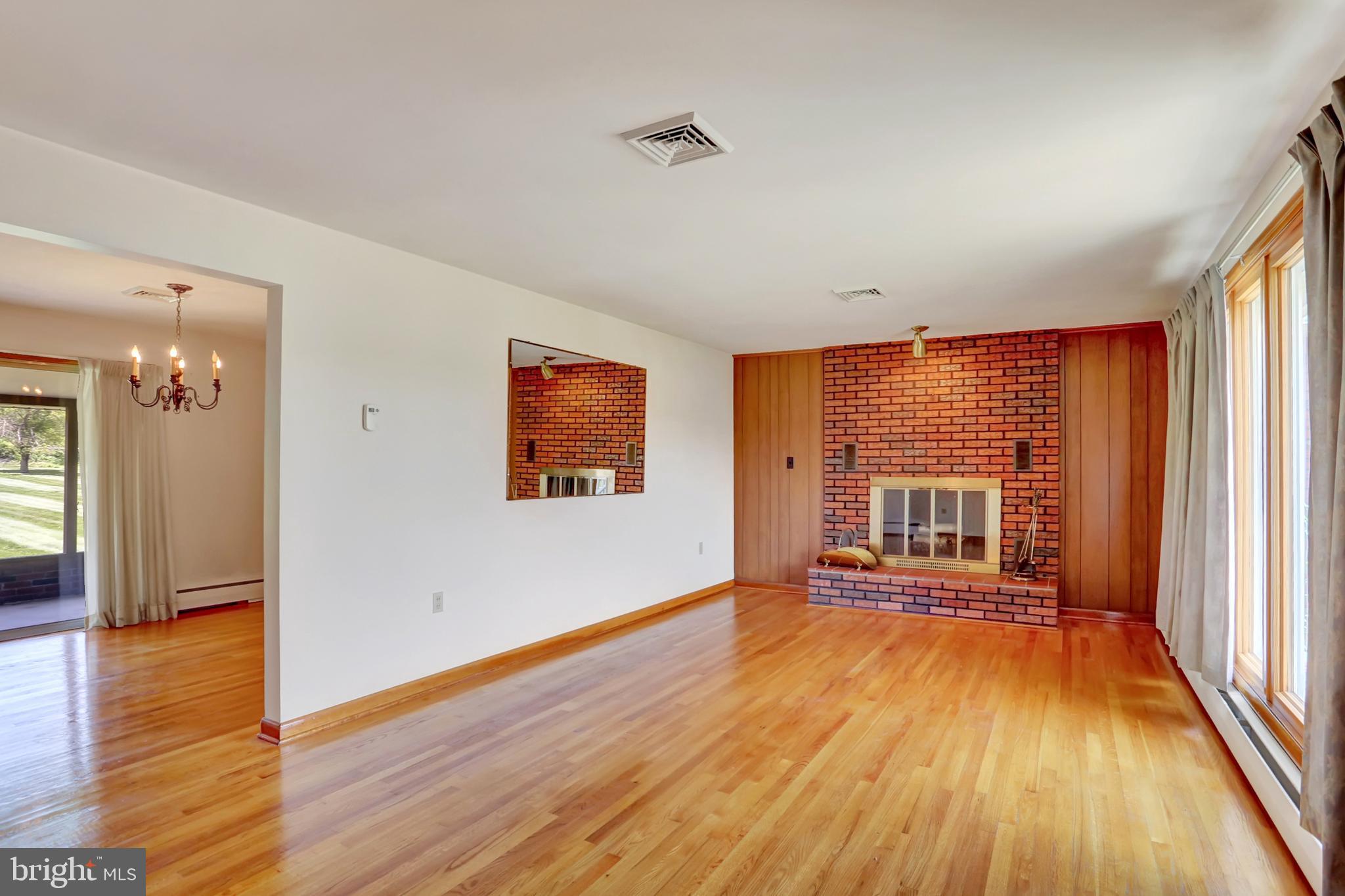 109 Ridgeview Drive Lewistown, PA 17044 - Photo 11 of 40 an empty room with wooden floor and windows