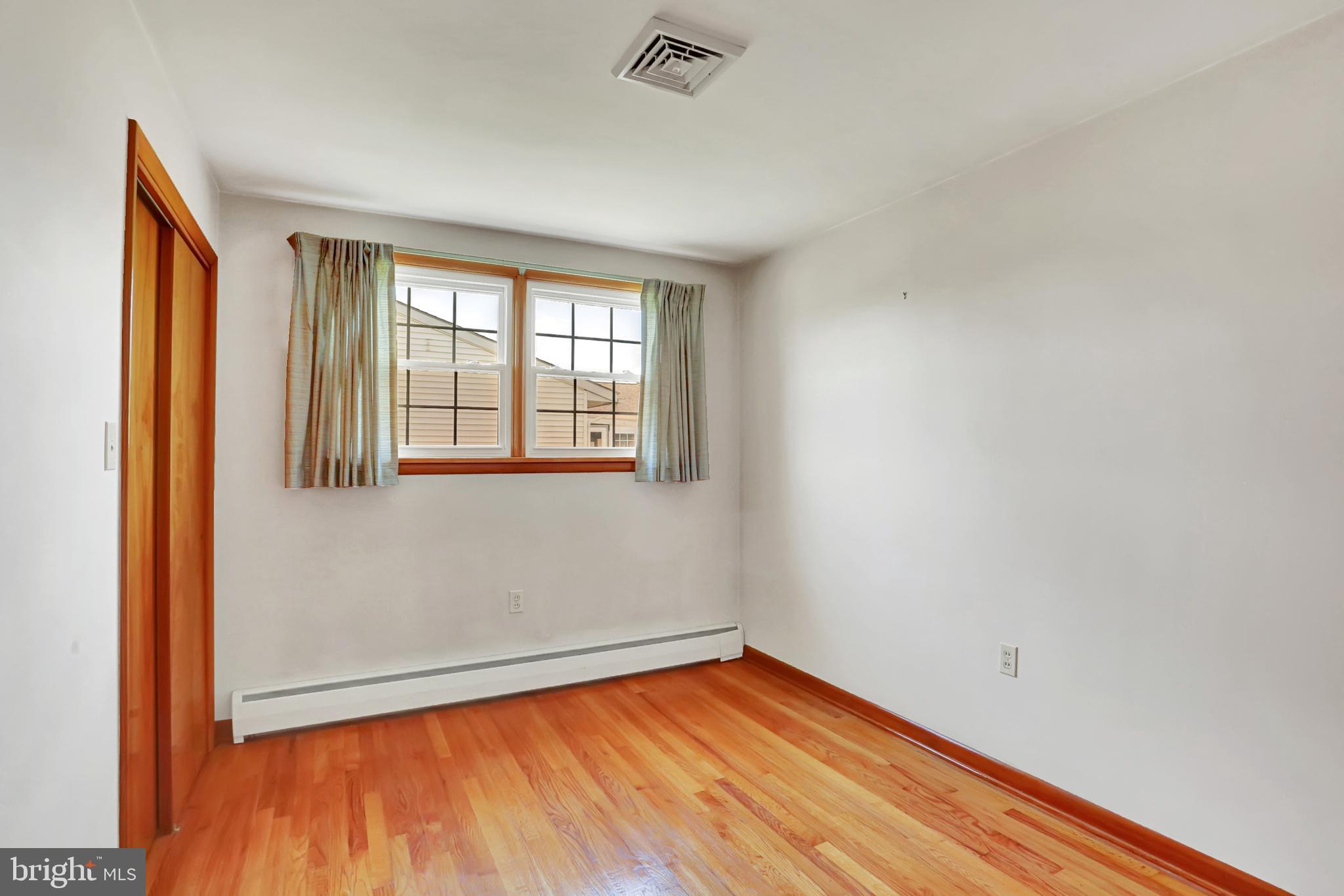109 Ridgeview Drive Lewistown, PA 17044 - Photo 24 of 40 an empty room with wooden floor and windows