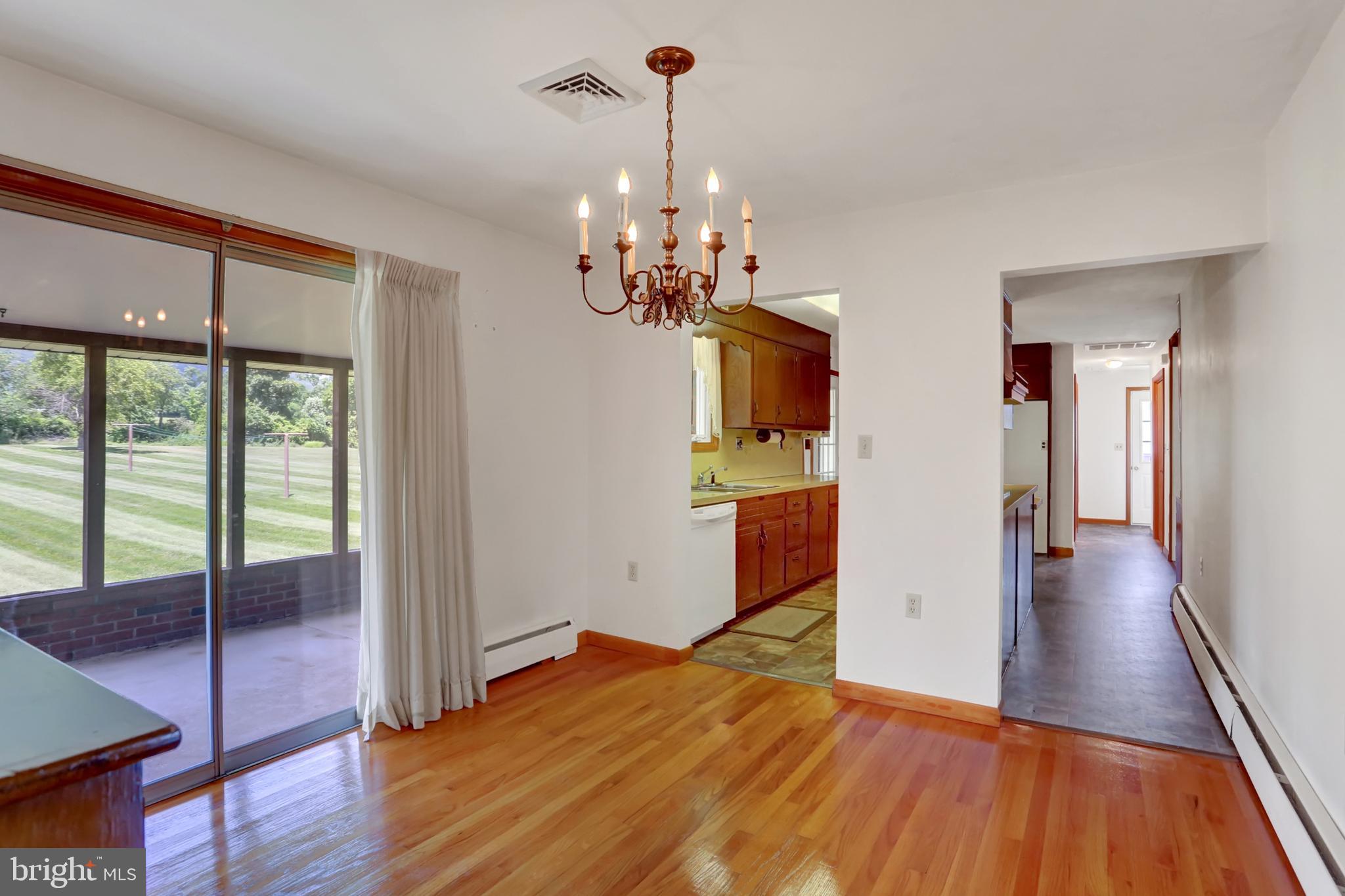 109 Ridgeview Drive Lewistown, PA 17044 - Photo 10 of 40 a view of a room with wooden floor staircase and a kitchen