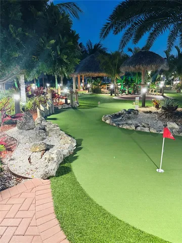 a room with wooden pool table and couches