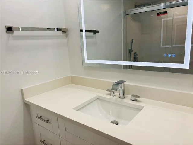 a bathroom with a sink and shower
