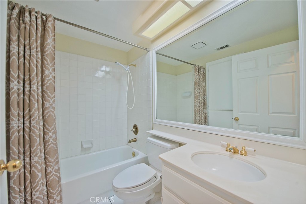 25554 Hemingway Avenue, Unit A Stevenson Ranch, CA 91381 - Photo 12 of 15 a bathroom with a bathtub shower sink vanity and toilet