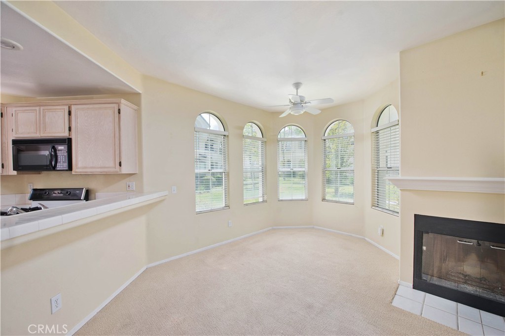 25554 Hemingway Avenue, Unit A Stevenson Ranch, CA 91381 - Photo 5 of 15 a view of a kitchen with a sink a fireplace and windows