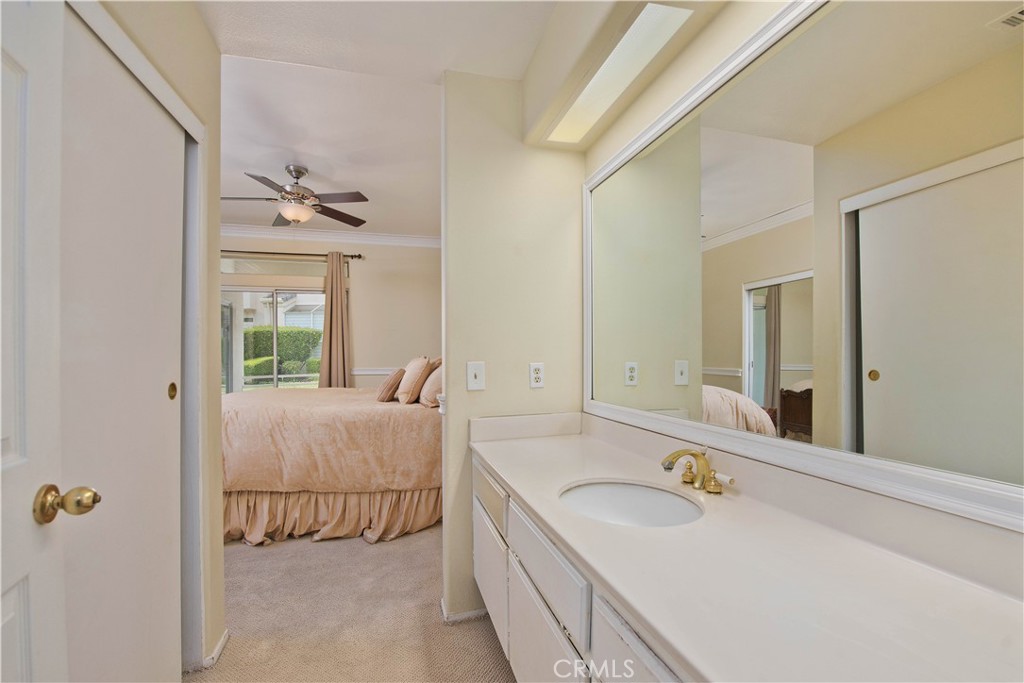 25554 Hemingway Avenue, Unit A Stevenson Ranch, CA 91381 - Photo 10 of 15 a bathroom with a granite countertop sink and a mirror