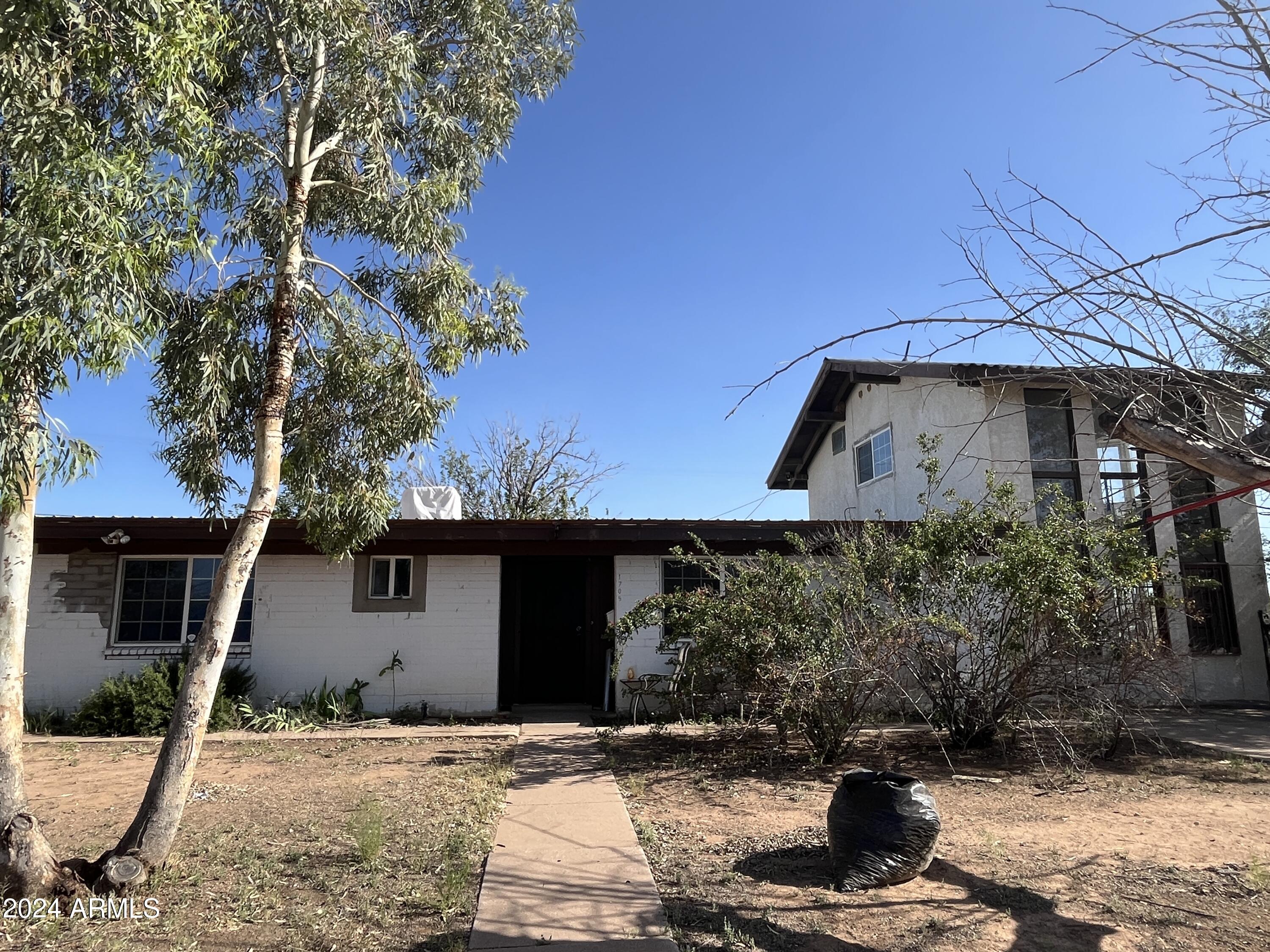 1705 6th Green Street Douglas, AZ 85607 - Photo 2 of 11 a front view of a house with garden