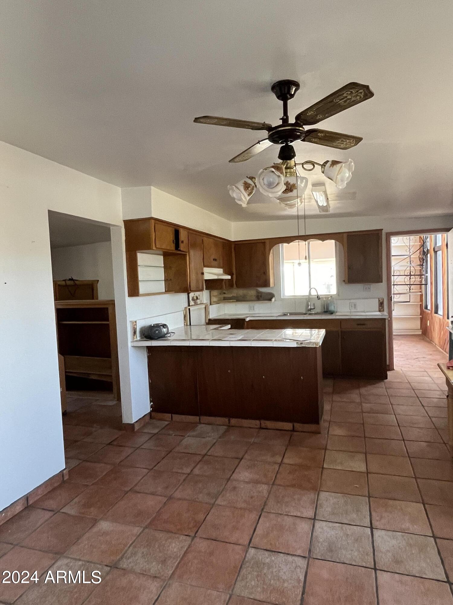 1705 6th Green Street Douglas, AZ 85607 - Photo 3 of 11 a large kitchen with granite countertop a stove a sink and a refrigerator