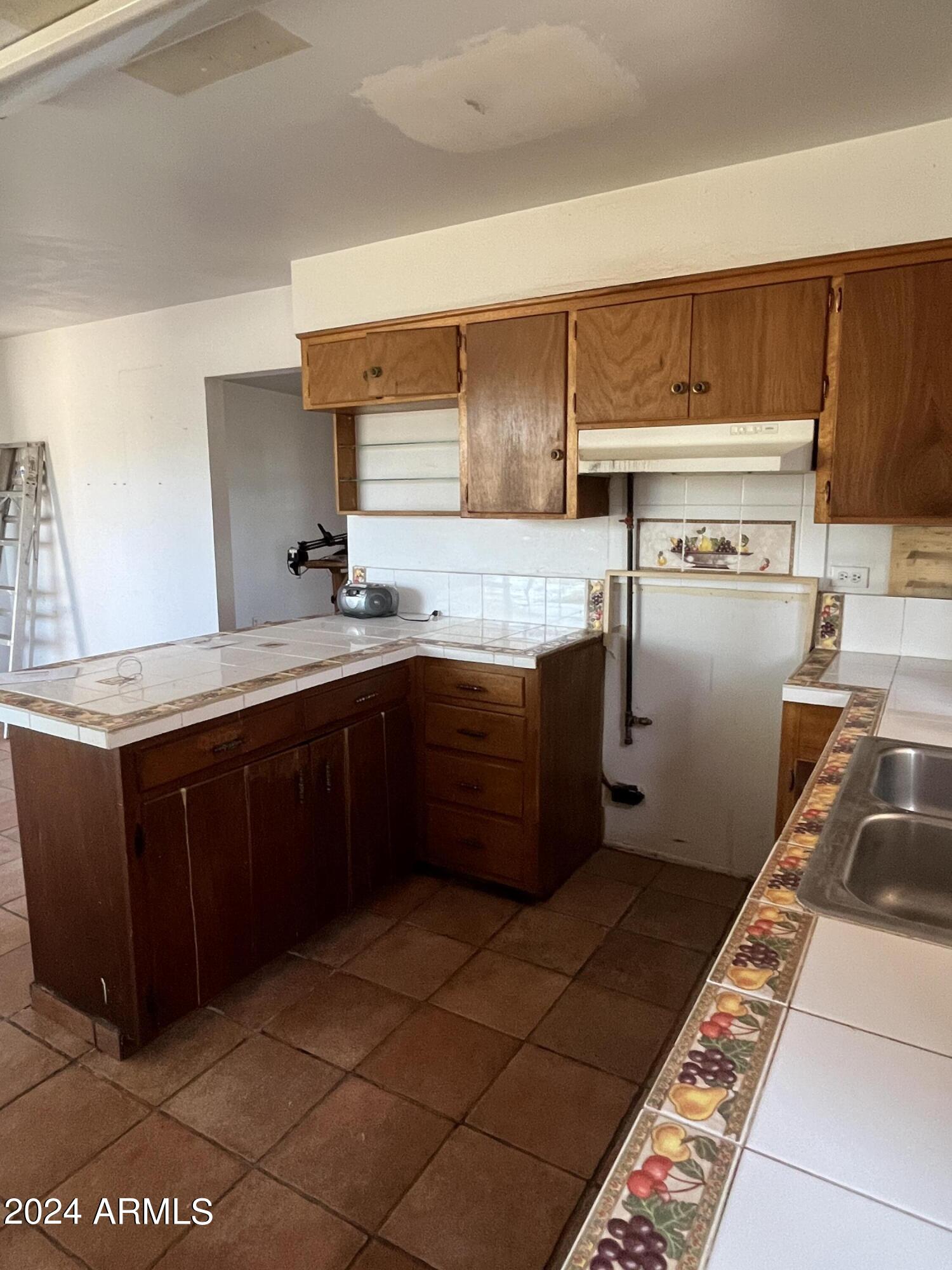 1705 6th Green Street Douglas, AZ 85607 - Photo 6 of 11 a kitchen with a sink a stove and cabinets
