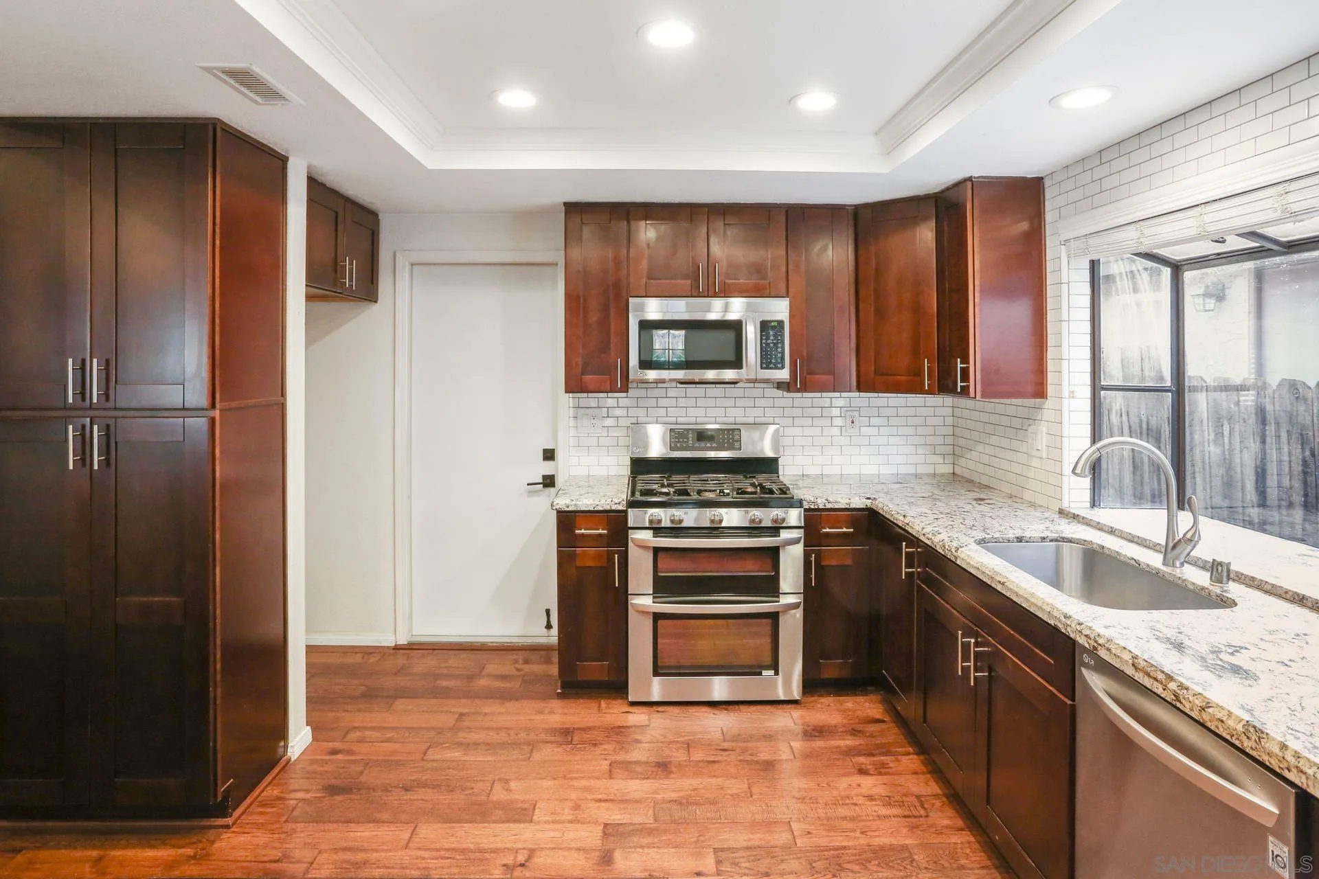 9260 Sombria Road Lakeside, CA 92040 - Photo 11 of 31 a kitchen with stainless steel appliances granite countertop a refrigerator a sink a stove top oven and a refrigerator
