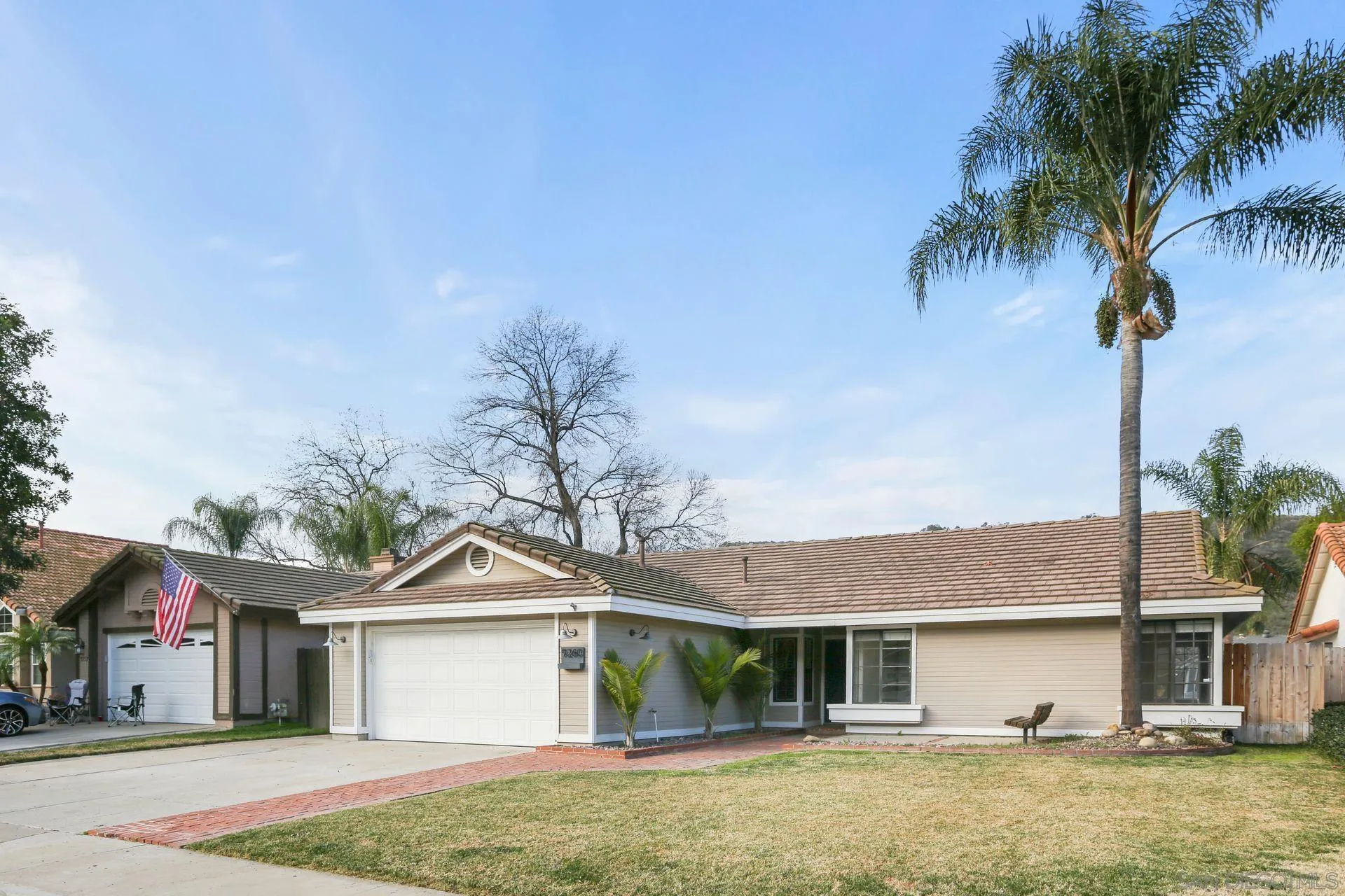 9260 Sombria Road Lakeside, CA 92040 - Photo 3 of 31 a front view of a house with a garden and patio