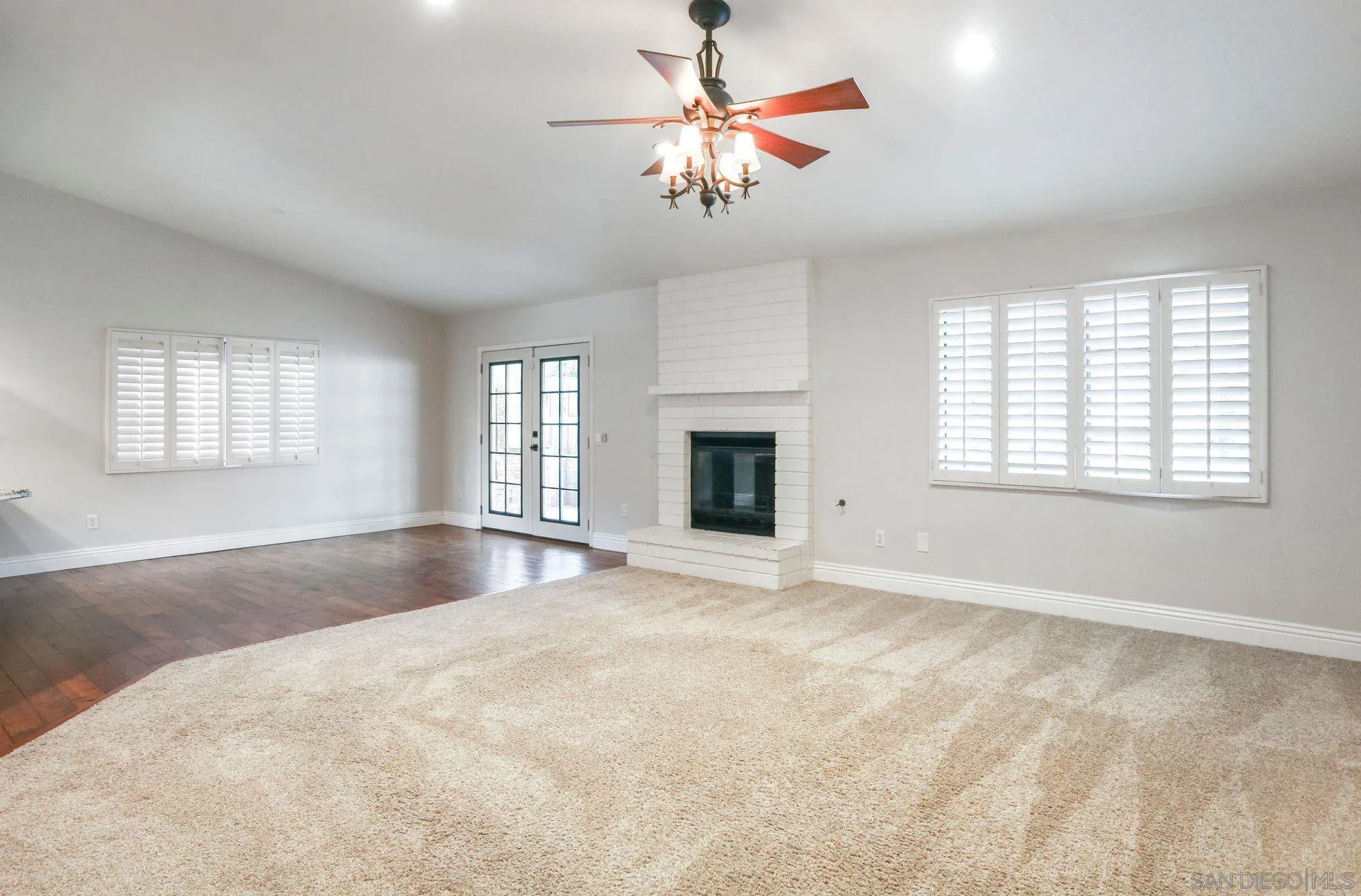 9260 Sombria Road Lakeside, CA 92040 - Photo 6 of 31 an empty room with windows and fireplace