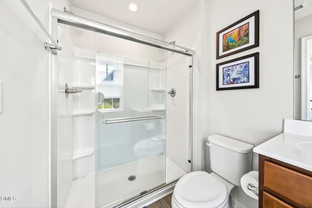 a white toilet sitting next to a bathroom sink
