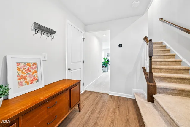 a view of front door with wooden floor and stairs