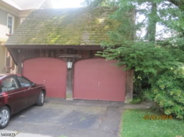 a front view of a house with trees