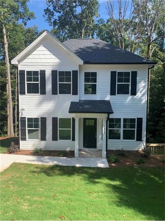 4985 Wisdom Road Cumming, GA 30041 - Photo 1 of 1 a front view of a house with a yard and trees