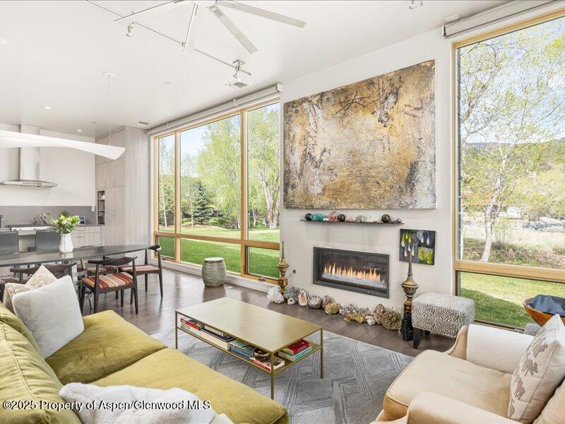 102 Evans Road, Unit 107 Basalt, CO 81621 - Photo 4 of 25 a living room with furniture a fireplace and a large window with balcony view