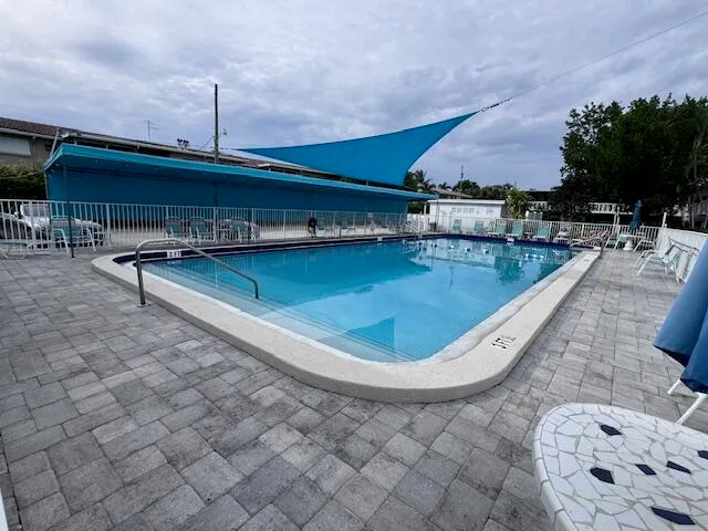 a view of a swimming pool with outdoor seating
