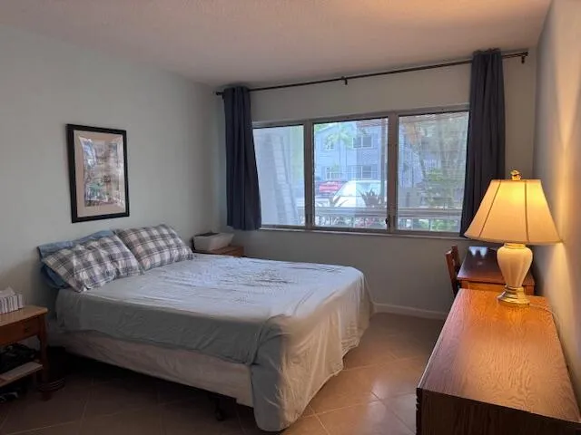 a bedroom with a bed and a night stand