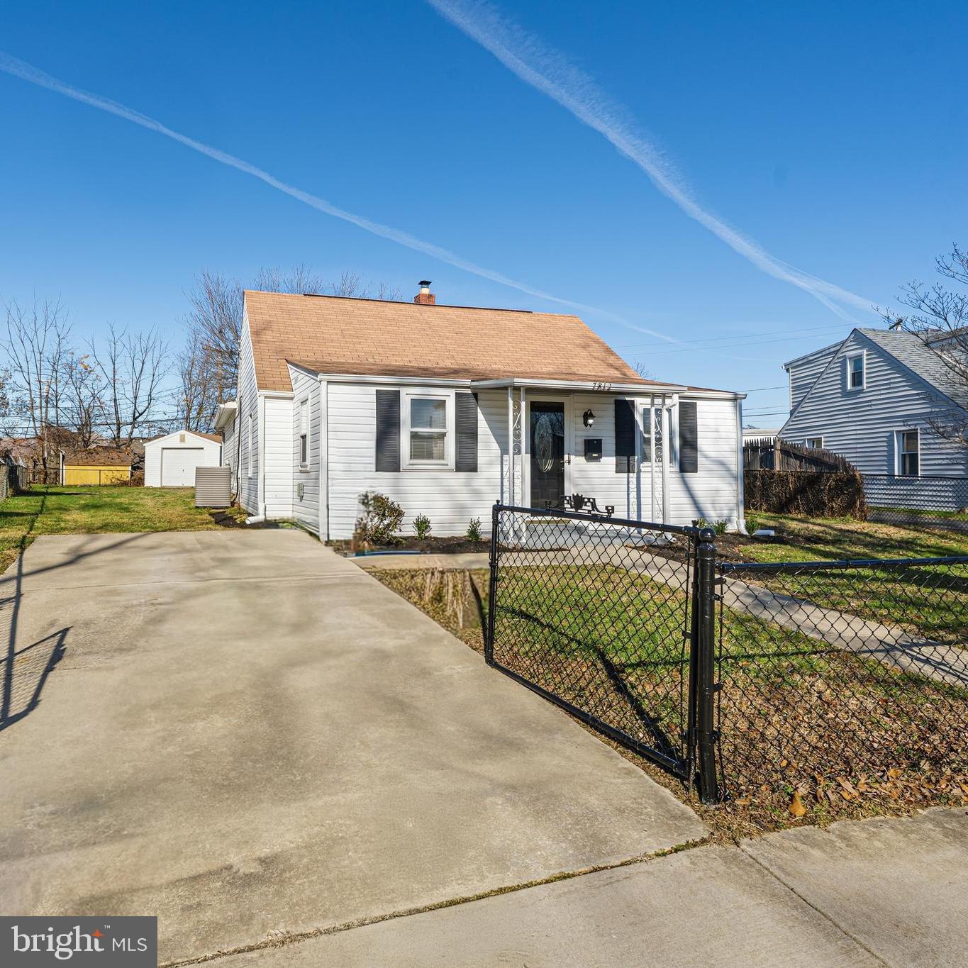a view of a house with wooden fence