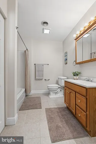 a spacious bathroom with a tub sink and mirror