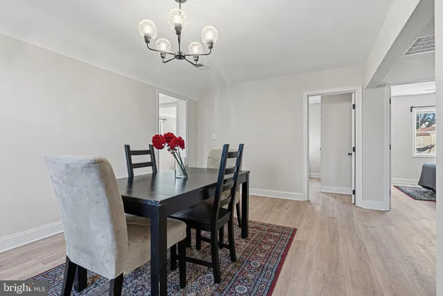 a view of a dining room with furniture wooden floor and chandelier