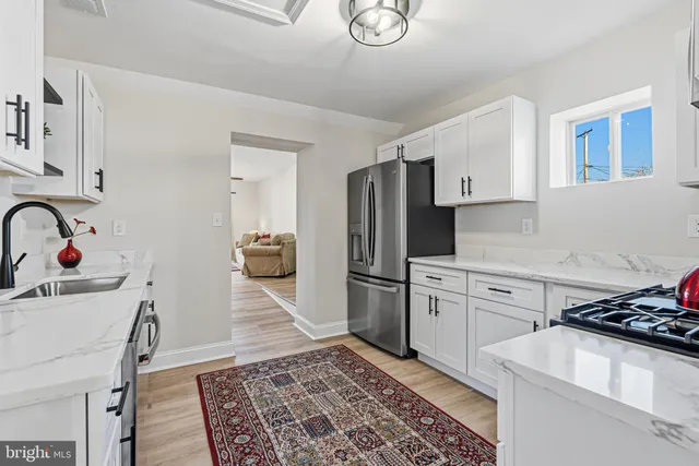 a kitchen with a sink appliances and cabinets