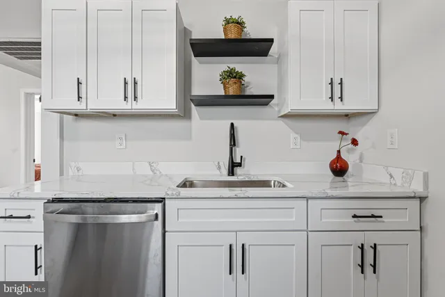 a kitchen with white cabinets and a sink