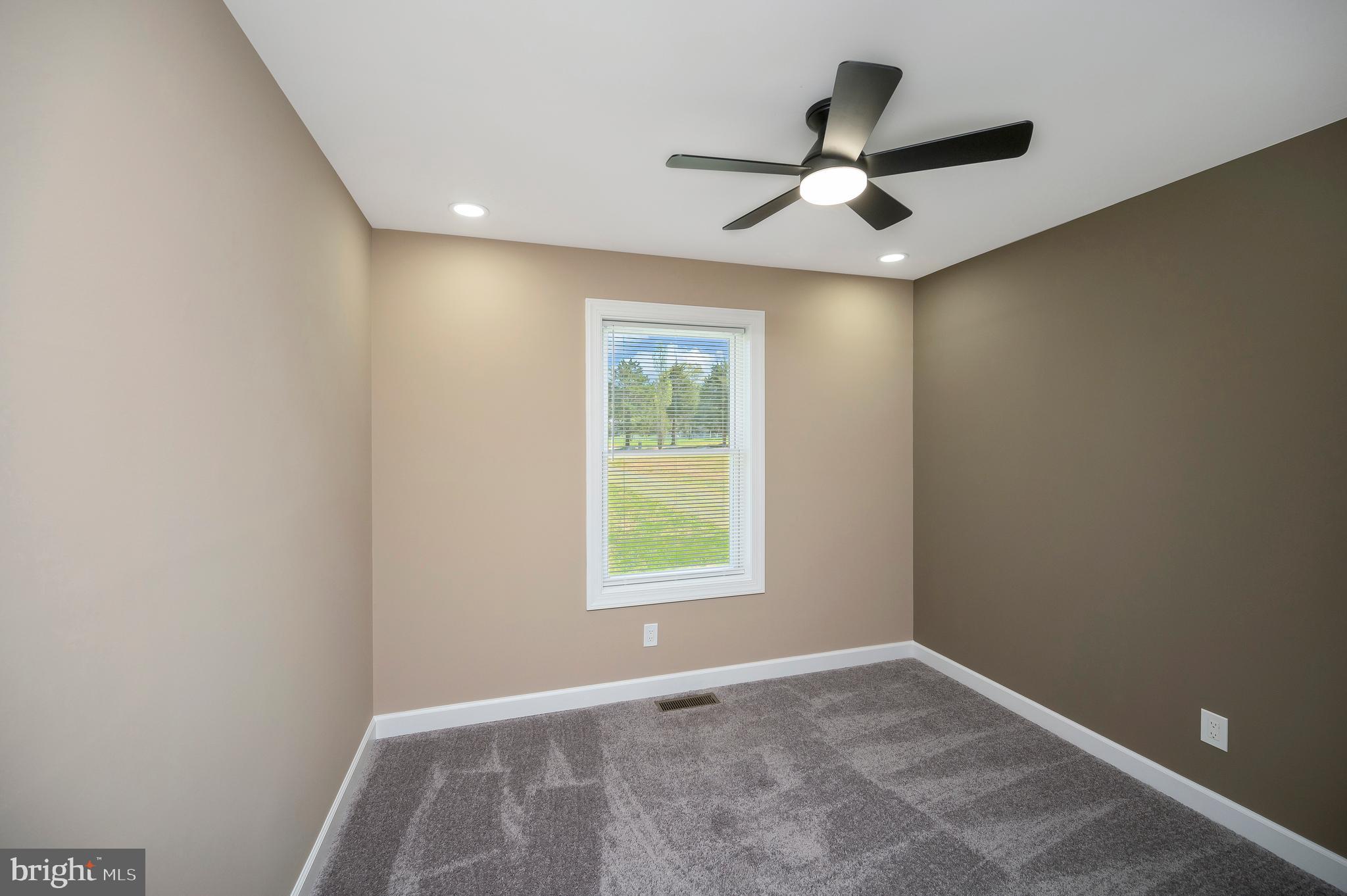 13452 Post Oak Road Spotsylvania, VA 22551 - Photo 35 of 56 an empty room with ceiling fan and windows