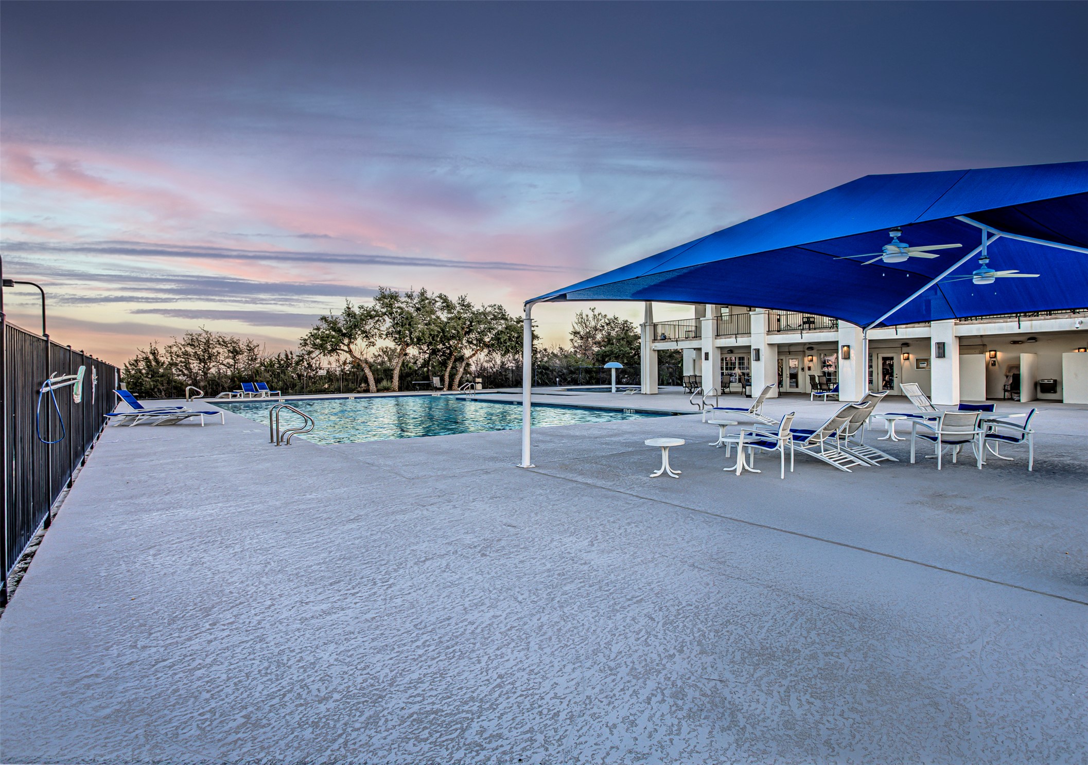 110 Sebastians Run Austin, TX 78738 - Photo 39 of 40 Pool at dusk with a community pool and a patio area